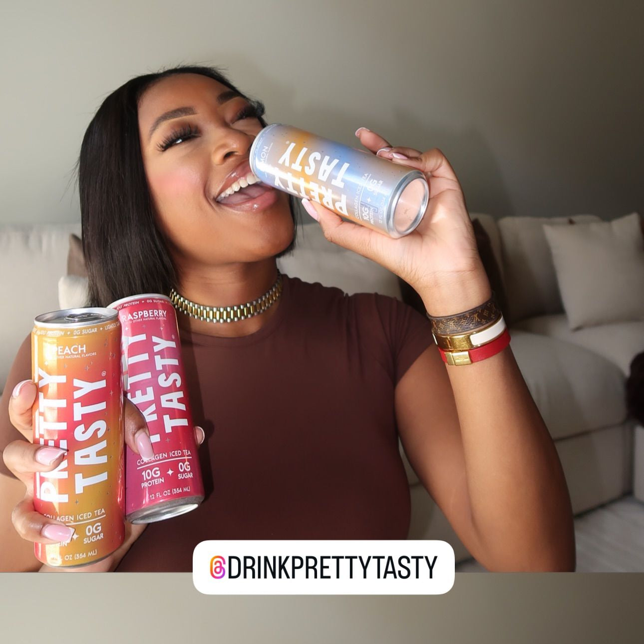 Woman holding and smiling with colorful drink cans in a casual setting