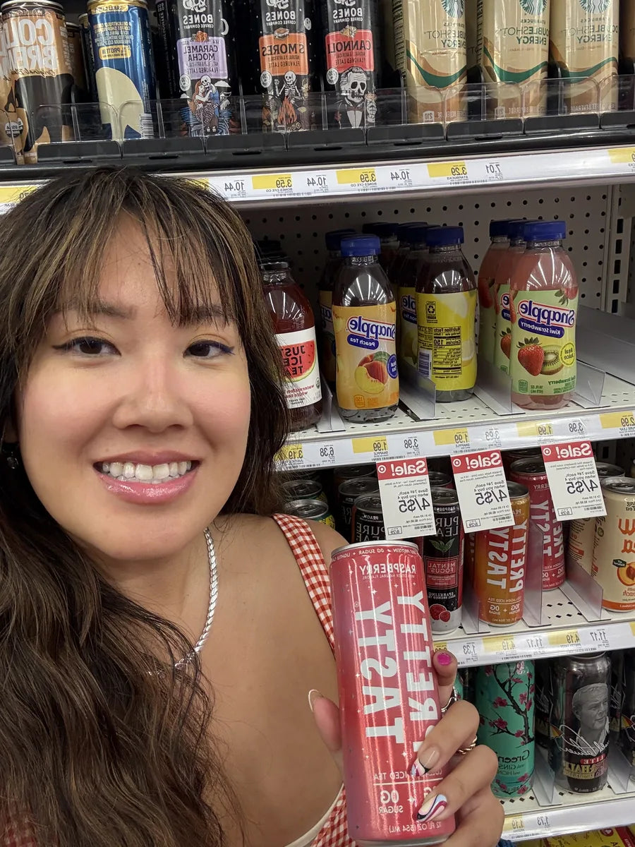 Shopper holding a Raspberry can in the Target tea aisle