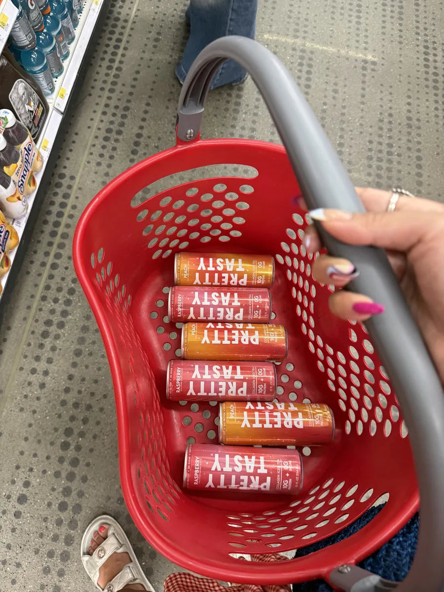 Six Pretty Tasty cans in a Target basket